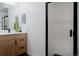 Modern bathroom with walk-in shower and wood-accented vanity at 2645 Eudora St, Denver, CO 80207