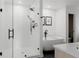 Sleek bathroom featuring a glass-enclosed shower, soaking tub, and modern fixtures at 2645 Eudora St, Denver, CO 80207