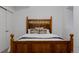 Cozy bedroom features detailed wood headboard and decorative pillows, offering a warm, inviting atmosphere at 2645 Eudora St, Denver, CO 80207