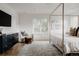 Bright primary bedroom showcasing a canopy bed, dresser, chair, and stylish decor at 2645 Eudora St, Denver, CO 80207