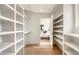 Spacious walk-in closet with custom shelving and hardwood floors, providing ample storage space at 2645 Eudora St, Denver, CO 80207