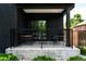 Inviting covered porch featuring modern railings and comfortable seating, perfect for relaxing outdoors at 2645 Eudora St, Denver, CO 80207