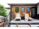 Outdoor deck with lounge chairs offers a relaxing space with wood details on the exterior at 2645 Eudora St, Denver, CO 80207