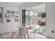 Bright dining area with modern table and chairs opens to an outdoor patio and backyard at 2645 Eudora St, Denver, CO 80207
