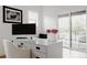 Bright and airy home office with a large desk, natural light, and balcony access at 2645 Eudora St, Denver, CO 80207