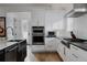 Well-equipped kitchen featuring stainless steel appliances, white cabinetry, and modern finishes at 2645 Eudora St, Denver, CO 80207
