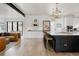 Open-concept kitchen featuring a large island, modern appliances, and seamless flow to the living area at 2645 Eudora St, Denver, CO 80207