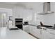 Modern kitchen with white cabinets, stainless steel appliances, and a stylish gas range at 2645 Eudora St, Denver, CO 80207