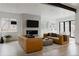 Bright living room showcasing leather sofas, contemporary decor, and a modern fireplace feature wall at 2645 Eudora St, Denver, CO 80207