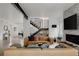 Stylish living room featuring a comfortable leather sofa, modern fireplace, and sleek staircase design at 2645 Eudora St, Denver, CO 80207