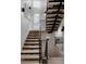 Bright staircase with light wood steps and black metal railings leads to the upper level at 2645 Eudora St, Denver, CO 80207