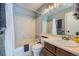 Bathroom with tile shower, vanity, and patterned flooring at 68 S Moline St, Aurora, CO 80012