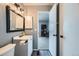 Bathroom featuring a white vanity and view to the bedroom at 68 S Moline St, Aurora, CO 80012