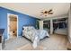 Bright bedroom featuring carpet floors, a ceiling fan, closet, and an ensuite bathroom with a tub at 68 S Moline St, Aurora, CO 80012
