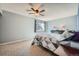A peaceful bedroom with a ceiling fan and a large window, offering plenty of natural light at 68 S Moline St, Aurora, CO 80012