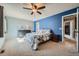 Bedroom with blue accent wall, gray dresser, ceiling fan, and carpet at 68 S Moline St, Aurora, CO 80012