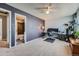 Bedroom featuring a large desk setup, ceiling fan, and ensuite bathroom with tiled shower-tub combo at 68 S Moline St, Aurora, CO 80012