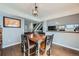 Dining area features hardwood floors, a wooden table and access to a kitchen space at 68 S Moline St, Aurora, CO 80012