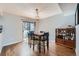 Dining area featuring hardwood floors, sliding glass doors to outdoor space, and elegant lighting at 68 S Moline St, Aurora, CO 80012