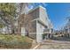 Exterior view of the side of the home with gray siding and a driveway at 68 S Moline St, Aurora, CO 80012
