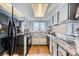 A spacious kitchen featuring gray cabinets, marble countertops, and modern appliances at 68 S Moline St, Aurora, CO 80012