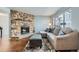 Relaxing living room features a stone fireplace, hardwood floors and abundant natural light at 68 S Moline St, Aurora, CO 80012