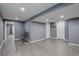 Finished basement with gray walls, light wood floors, recessed lighting, and access to other rooms at 1150 W 127Th Ct, Denver, CO 80234