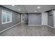 Finished basement with gray walls, light wood floors, recessed lighting, and access to other rooms at 1150 W 127Th Ct, Denver, CO 80234