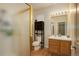 Bright bathroom featuring a glass shower, wood-style floors, and a wood vanity with sink at 1150 W 127Th Ct, Denver, CO 80234