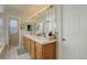 Large bathroom with double vanity, tile floors, and a large mirror with Hollywood style lighting at 1150 W 127Th Ct, Denver, CO 80234