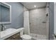 Updated bathroom featuring stylish tile work, a glass-enclosed shower, and a modern vanity at 1150 W 127Th Ct, Denver, CO 80234