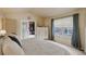 Bright primary bedroom featuring vaulted ceilings, carpet, a large window, and walk-in closet at 1150 W 127Th Ct, Denver, CO 80234