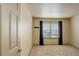 Bedroom featuring neutral carpet, black-out curtains, and a large window overlooking the yard at 1150 W 127Th Ct, Denver, CO 80234
