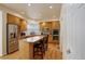 Well-lit kitchen with stainless steel appliances, granite countertops, wood cabinets and hardwood floors at 1150 W 127Th Ct, Denver, CO 80234
