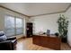 Office with wooden desk, bookshelf, a comfortable black leather chair and plenty of natural light at 1150 W 127Th Ct, Denver, CO 80234