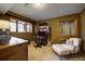 Finished basement with a charming study, desk and chair with a comfortable sitting area at 1334 Solitude Ln, Evergreen, CO 80439