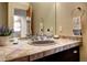 Bathroom vanity with dual sinks, neutral colors, and decorative tile at 1334 Solitude Ln, Evergreen, CO 80439