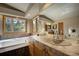 Bright bathroom with a soaking tub, a tiled countertop, and a large window with scenic views at 1334 Solitude Ln, Evergreen, CO 80439