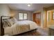 Cozy bedroom with carpet flooring, double closet, and a window with scenic outdoor views at 1334 Solitude Ln, Evergreen, CO 80439