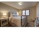 Bedroom with carpet flooring, a window with scenic views, and a side table with a lamp at 1334 Solitude Ln, Evergreen, CO 80439