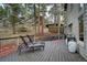 Inviting deck with lounge chairs surrounded by mature trees and scenic views at 1334 Solitude Ln, Evergreen, CO 80439