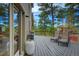 Inviting deck with lounge chairs surrounded by mature trees and scenic views at 1334 Solitude Ln, Evergreen, CO 80439