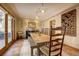 Elegant dining room with a large wooden table, stylish lighting, and a wine rack feature at 1334 Solitude Ln, Evergreen, CO 80439