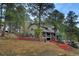 Two-story home with a stone accents surrounded by mature trees and wooded landscape at 1334 Solitude Ln, Evergreen, CO 80439
