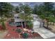Charming two-story home with a well-manicured yard and inviting deck, nestled among mature trees at 1334 Solitude Ln, Evergreen, CO 80439