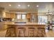 Bright kitchen with stone countertops, stainless appliances, and a breakfast bar area at 1334 Solitude Ln, Evergreen, CO 80439