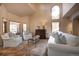 Bright living room with soaring ceilings, large windows, and comfortable seating with stylish decor at 1334 Solitude Ln, Evergreen, CO 80439