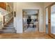 View of staircase and office space with desk and built-in shelving through double french doors at 1334 Solitude Ln, Evergreen, CO 80439