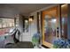 Inviting covered porch with comfortable seating area and stylish decor, including potted flowers at 1334 Solitude Ln, Evergreen, CO 80439