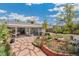 Landscaped backyard featuring a patio, garden beds, and mature trees at 3485 S Forest St, Denver, CO 80222